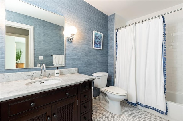 bathroom featuring toilet, vanity, and shower / tub combo with curtain