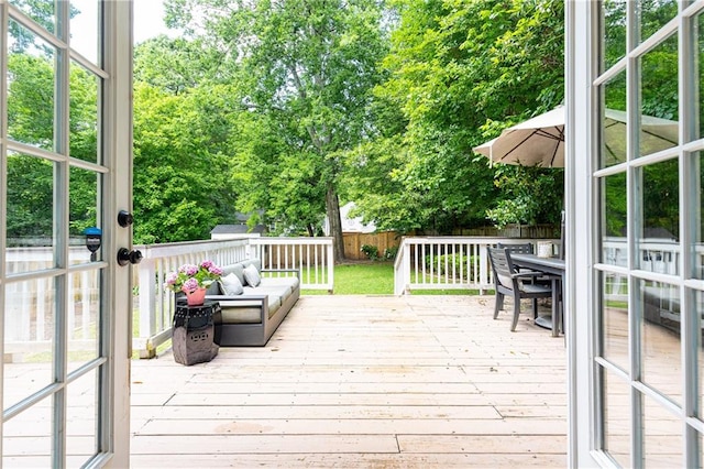wooden terrace with a fenced backyard