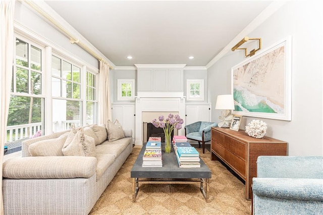 living area featuring ornamental molding and recessed lighting