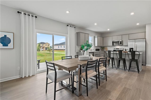 dining space with light hardwood / wood-style flooring