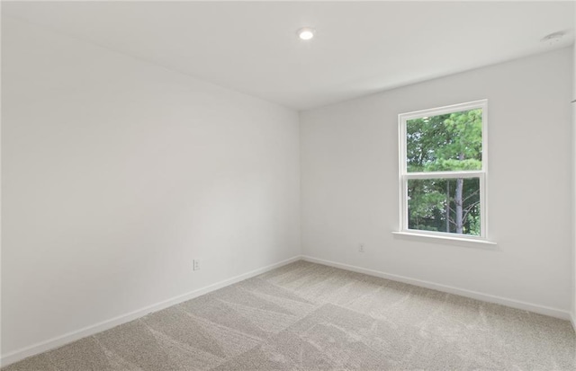 386 Rock View Ln, Covington, GA 30016 - spare room with baseboards, light carpet, and recessed lighting