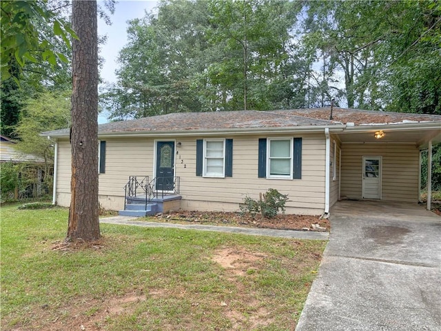 single story home featuring a front lawn and a carport