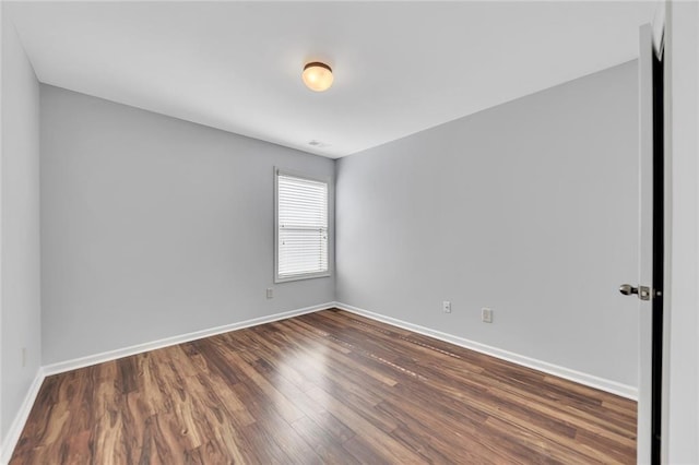 spare room featuring dark hardwood / wood-style floors