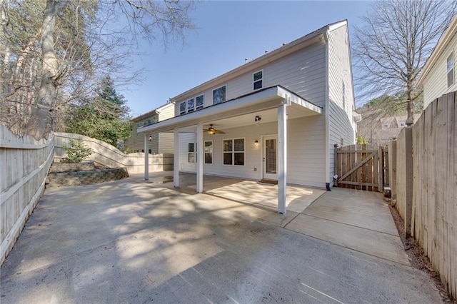 back of property featuring ceiling fan and a patio area