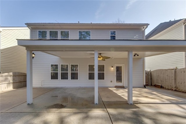 back of house with ceiling fan and a patio area