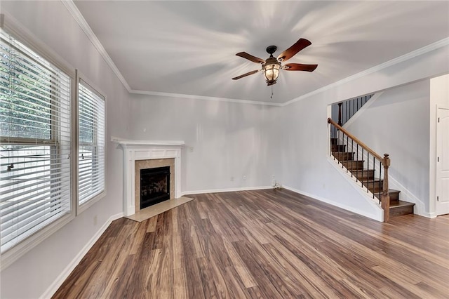 unfurnished living room with ornamental molding, wood-type flooring, and a premium fireplace