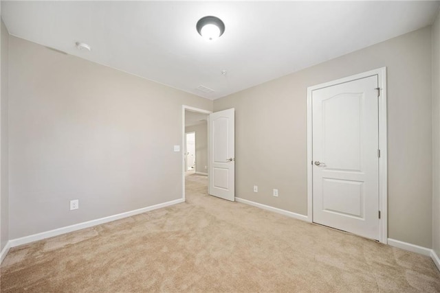 unfurnished bedroom with light carpet