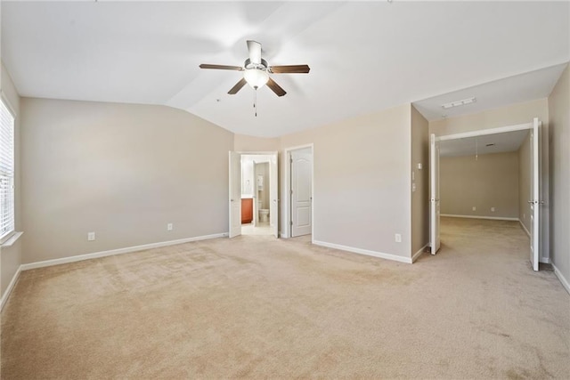 carpeted spare room with lofted ceiling and ceiling fan