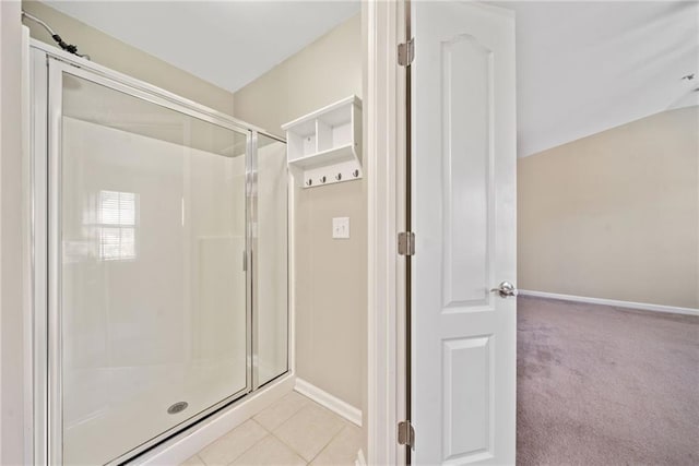 bathroom with tile patterned flooring and a shower with door