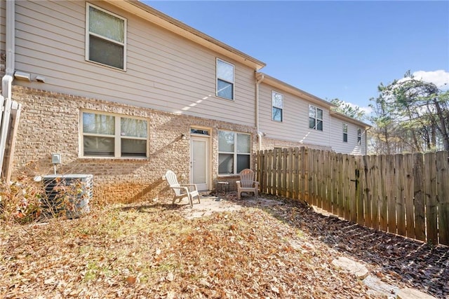 back of property featuring central AC unit