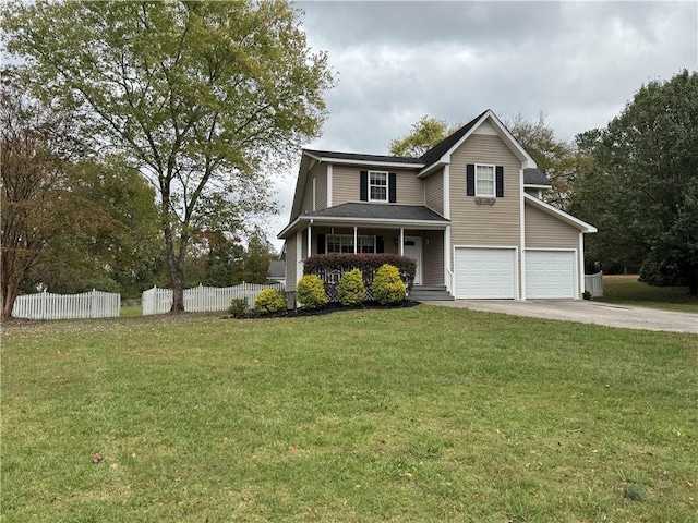 view of front of house with a front lawn, a garage, and covered porch