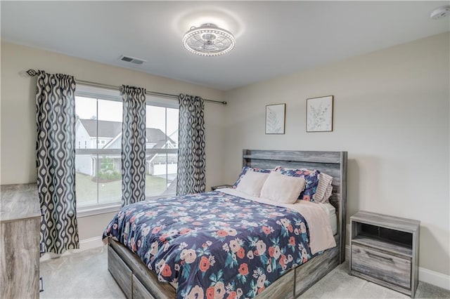 bedroom with carpet floors, visible vents, and baseboards