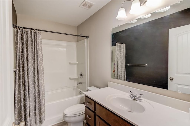 bathroom featuring shower / tub combo, toilet, vanity, and visible vents