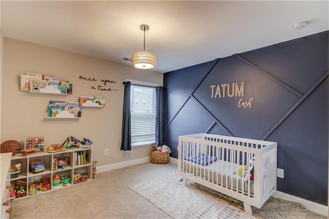 carpeted bedroom featuring a nursery area, baseboards, and visible vents