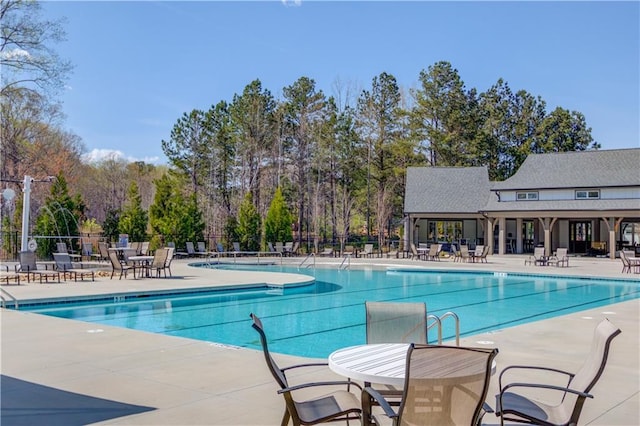 pool with fence and a patio