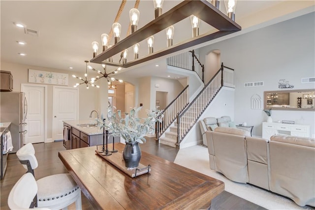 dining space with stairway, wood finished floors, and visible vents