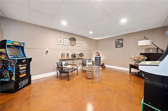 playroom featuring recessed lighting, concrete flooring, a paneled ceiling, and baseboards