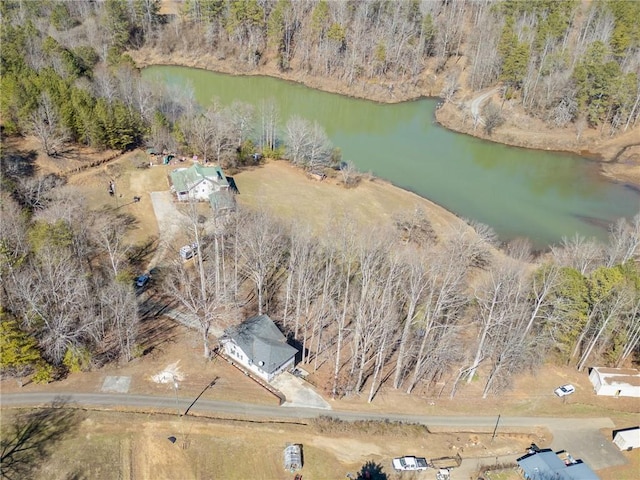 bird's eye view with a water view and a wooded view
