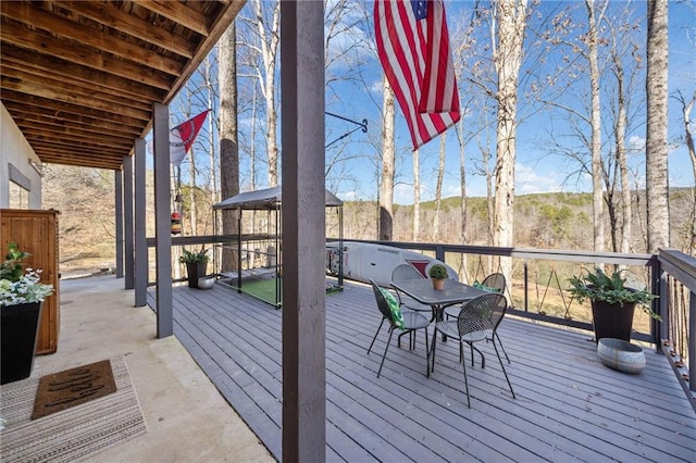 wooden terrace with outdoor dining area