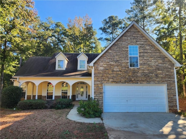 view of front of property with concrete driveway and a porch