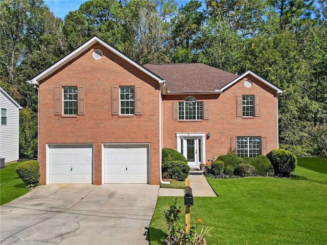 view of front of property with a garage and a front lawn