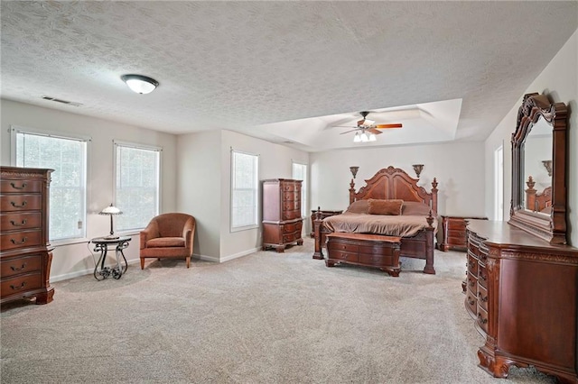 carpeted bedroom with a textured ceiling and ceiling fan