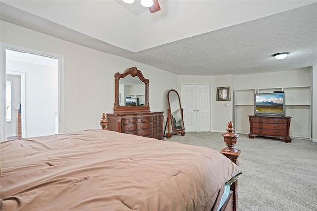 carpeted bedroom featuring a textured ceiling and ceiling fan