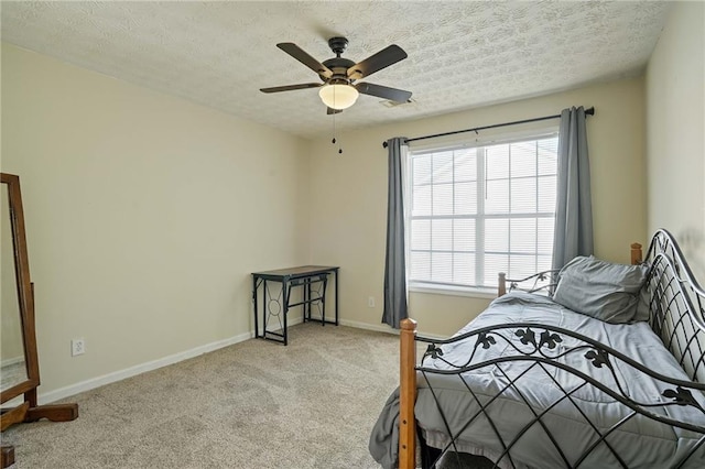 carpeted bedroom featuring a textured ceiling and ceiling fan