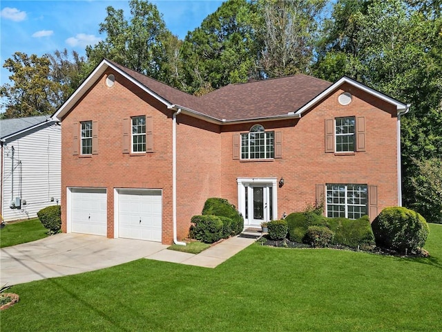 view of front of home with a garage and a front lawn