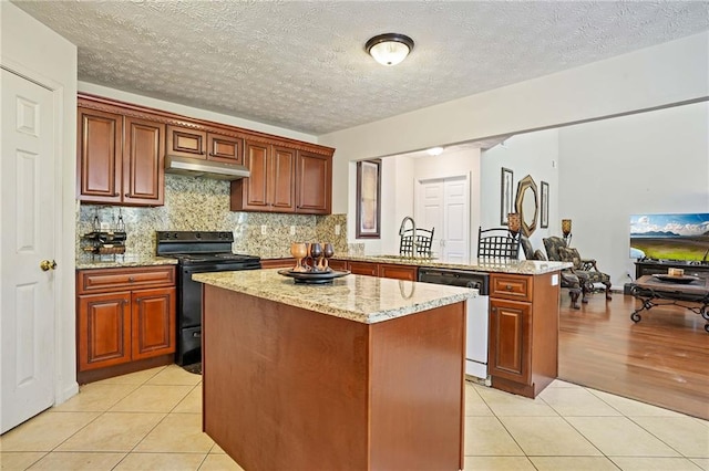 kitchen featuring dishwasher, a textured ceiling, a center island, electric range, and light hardwood / wood-style flooring