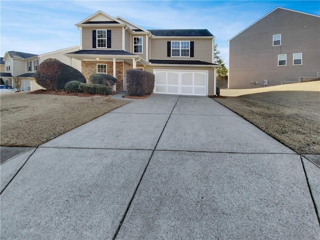 view of front of property featuring driveway and an attached garage