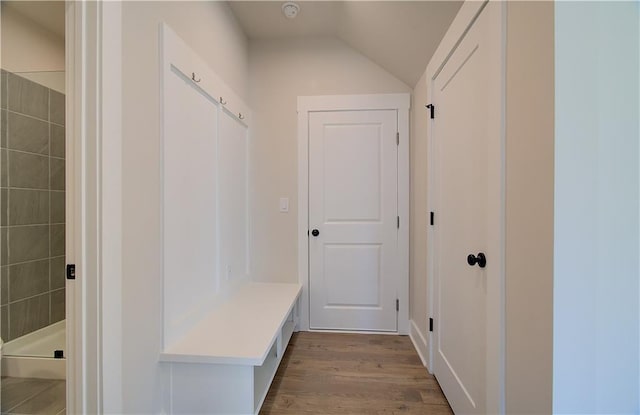 mudroom with lofted ceiling and wood finished floors