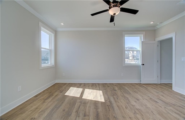 spare room featuring baseboards, ornamental molding, and wood finished floors