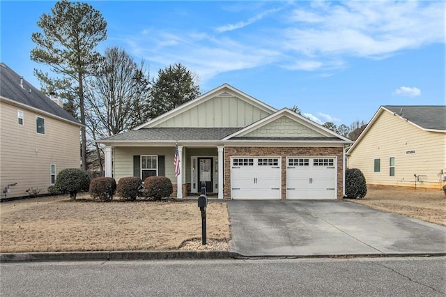 view of front facade with stone siding, a garage, board and batten siding, driveway, and a porch