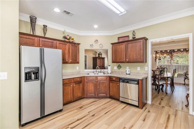 kitchen featuring light countertops, white refrigerator with ice dispenser, a sink, visible vents, and dishwasher
