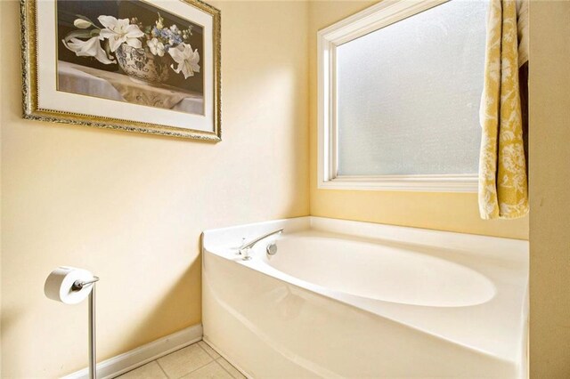 full bathroom featuring baseboards, a garden tub, and tile patterned flooring