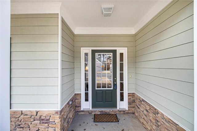 view of exterior entry with stone siding