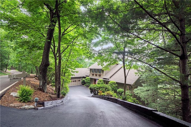 view of front facade featuring asphalt driveway and an attached garage