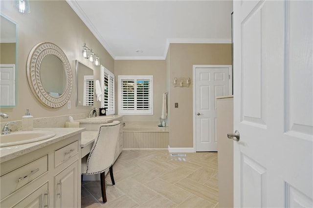 full bath featuring ornamental molding, vanity, a garden tub, and baseboards