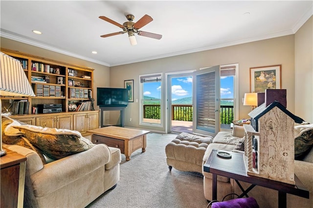 living room featuring carpet, crown molding, a ceiling fan, and recessed lighting
