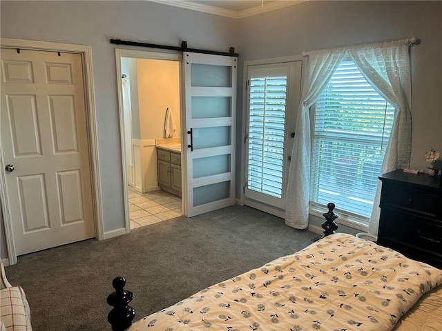 bedroom featuring light colored carpet, ornamental molding, a barn door, ensuite bath, and baseboards