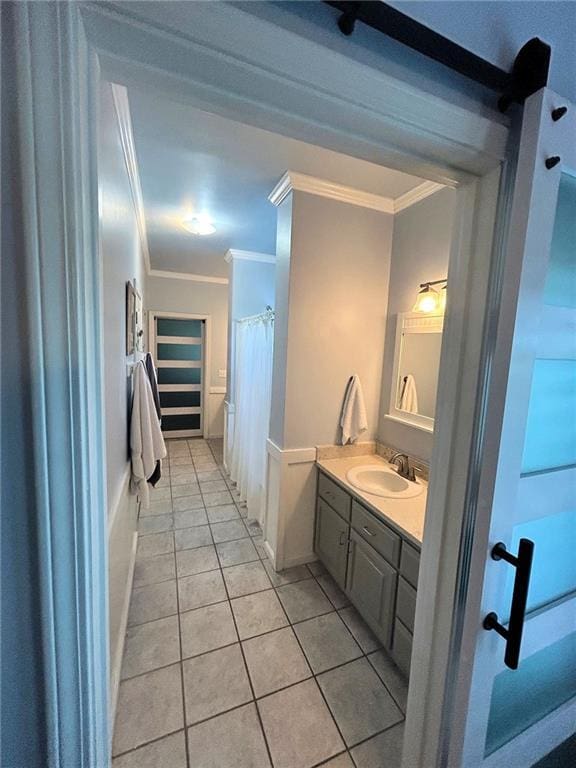 bathroom with crown molding, tile patterned floors, and vanity