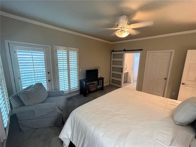 bedroom with a barn door, ornamental molding, baseboards, ceiling fan, and carpet flooring