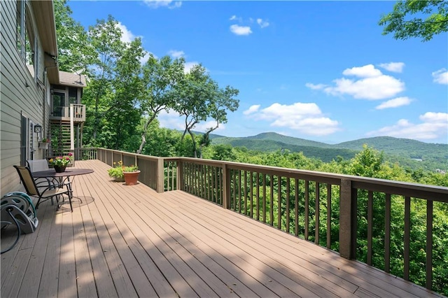 wooden deck featuring a mountain view and stairs