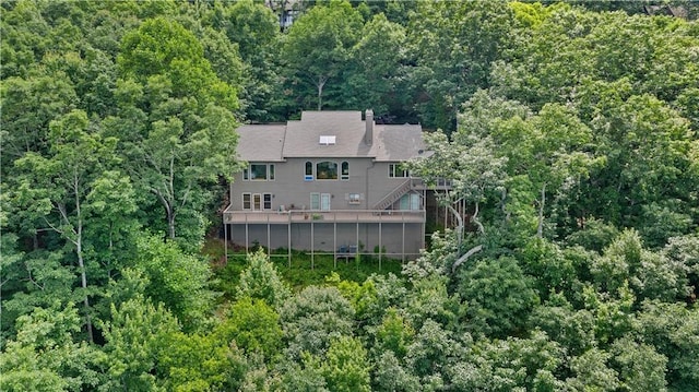 view of subject property with a heavily wooded area