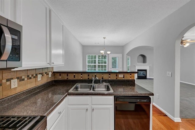 2165 Capella Cir S, Fulton, GA 30331 - kitchen featuring black dishwasher, stainless steel microwave, white cabinets, light wood finished floors, and a textured ceiling