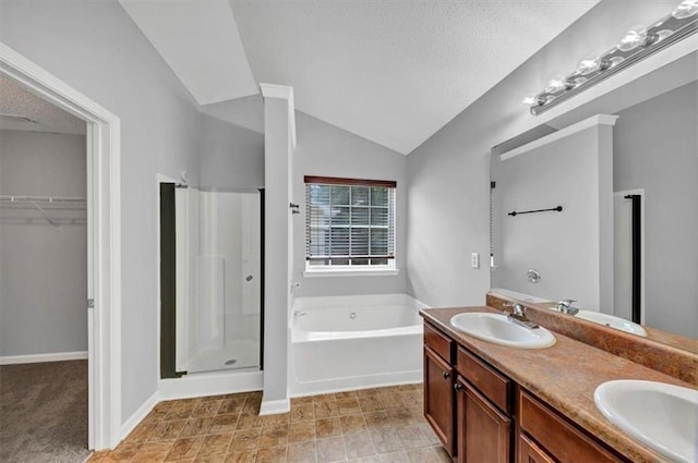 2165 Capella Cir S, Fulton, GA 30331 - full bathroom with a stall shower, a garden tub, double vanity, a spacious closet, and a textured ceiling