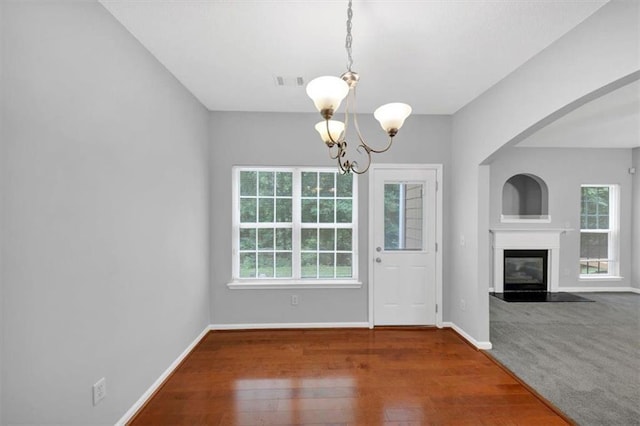 2165 Capella Cir S, Fulton, GA 30331 - unfurnished dining area with a chandelier, a glass covered fireplace, and wood finished floors