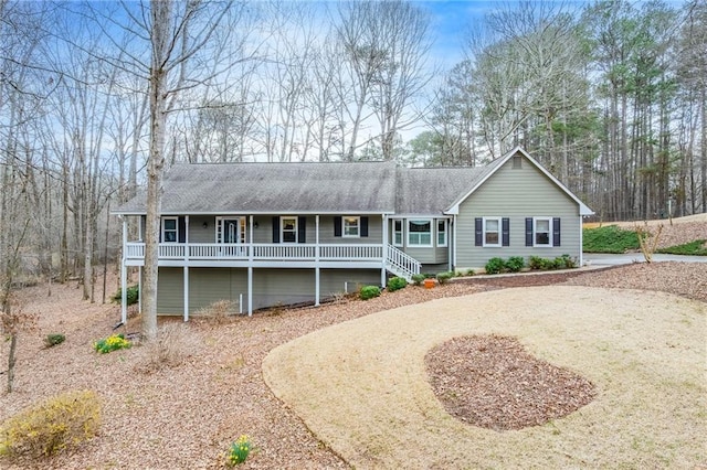 single story home featuring covered porch and a shingled roof