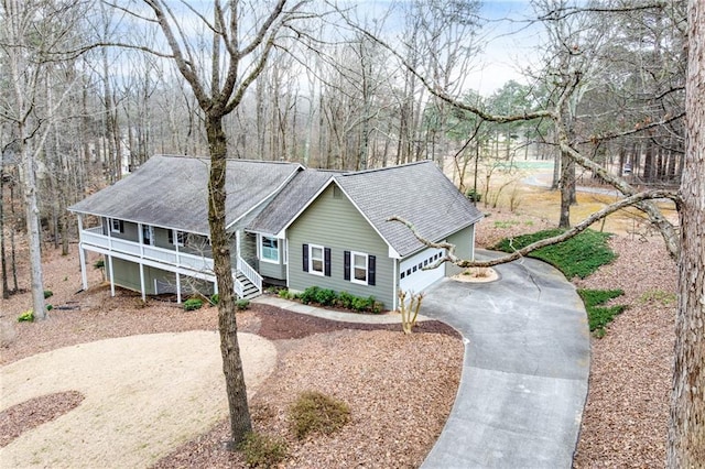 ranch-style home with a porch and driveway